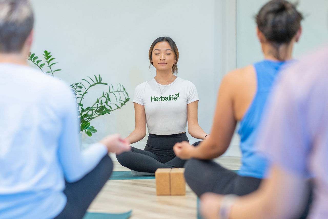 A woman teaches a yoga class