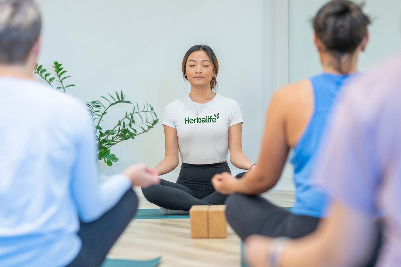 A woman teaches a yoga class