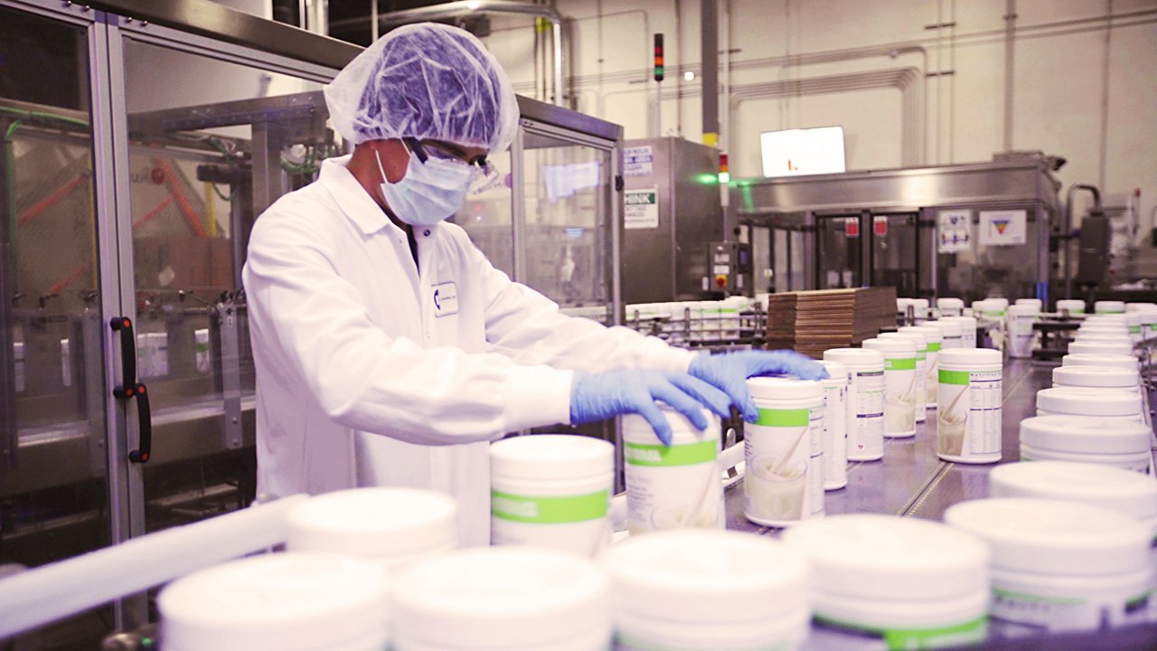 A facility worker inspecting Formula 1 products