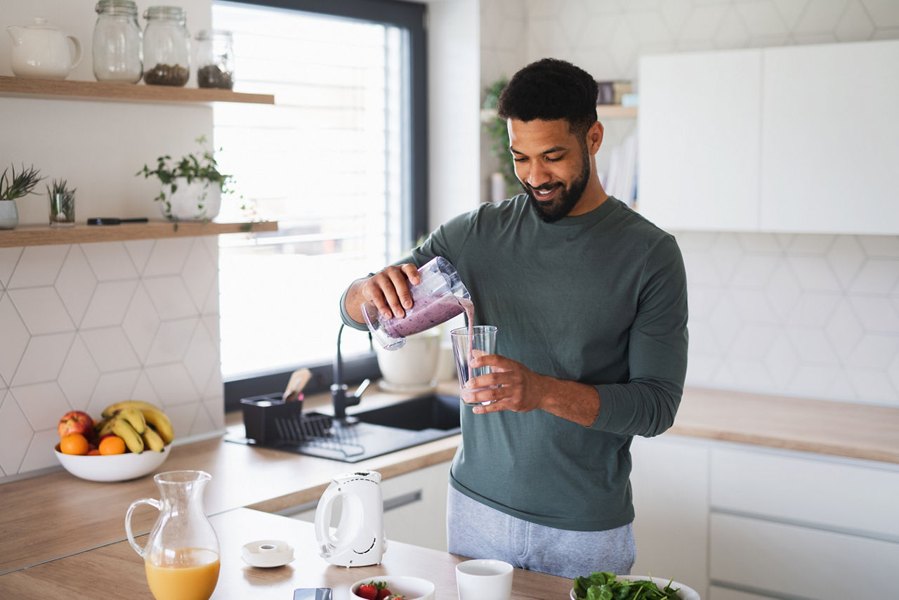 Man pouring shake into glass