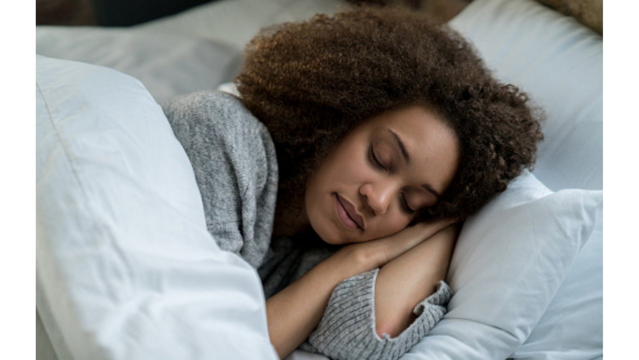 A woman asleep in bed​