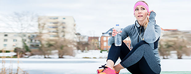 Woman resting from jogging or sport on winter day in the sun
