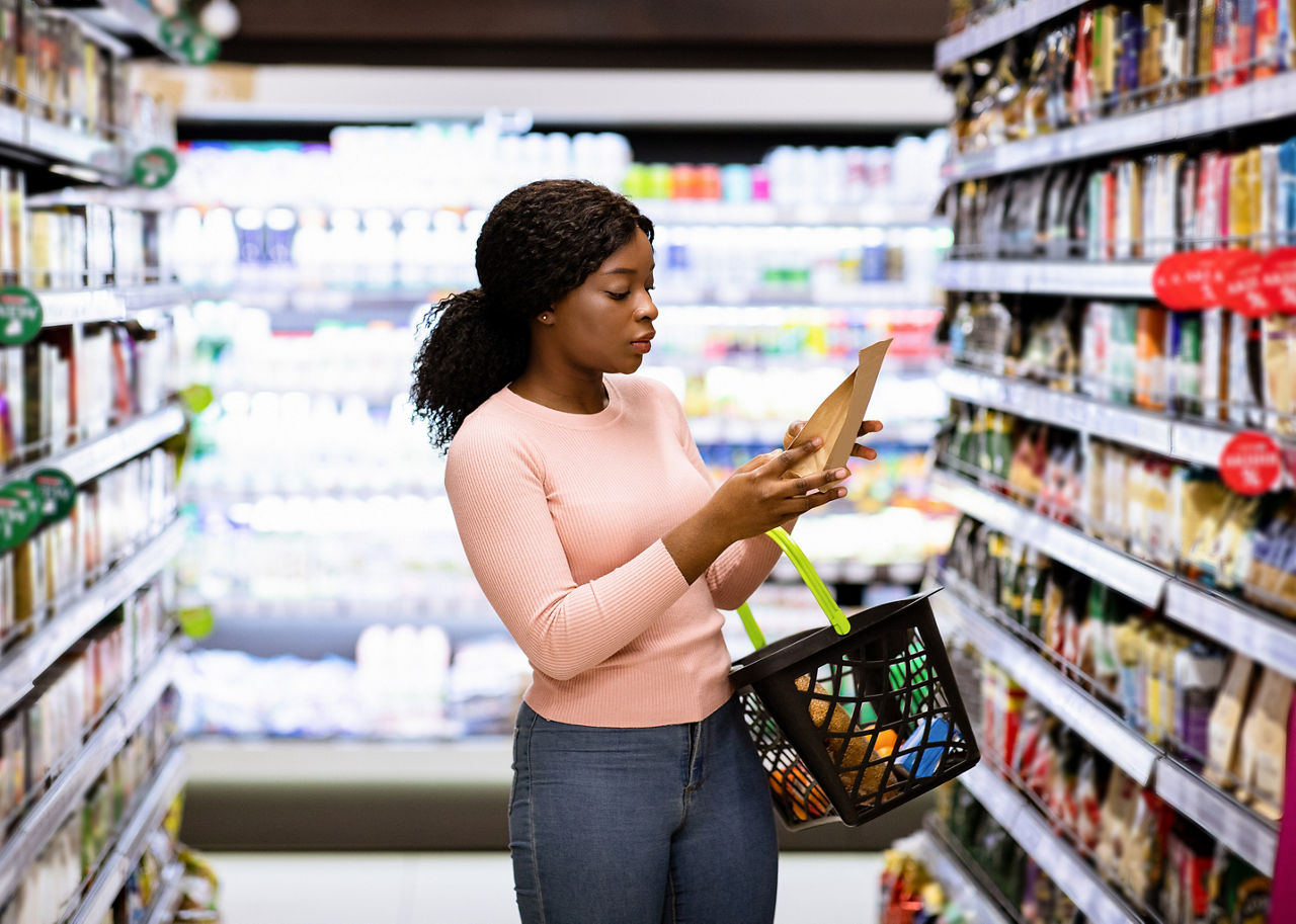 Woman reading product labels in the grocery store