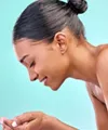 Beautiful woman washing her face