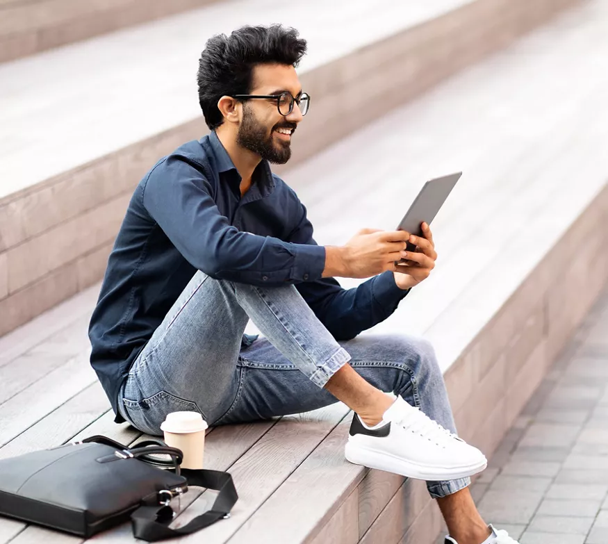 Man on ipad outdoors